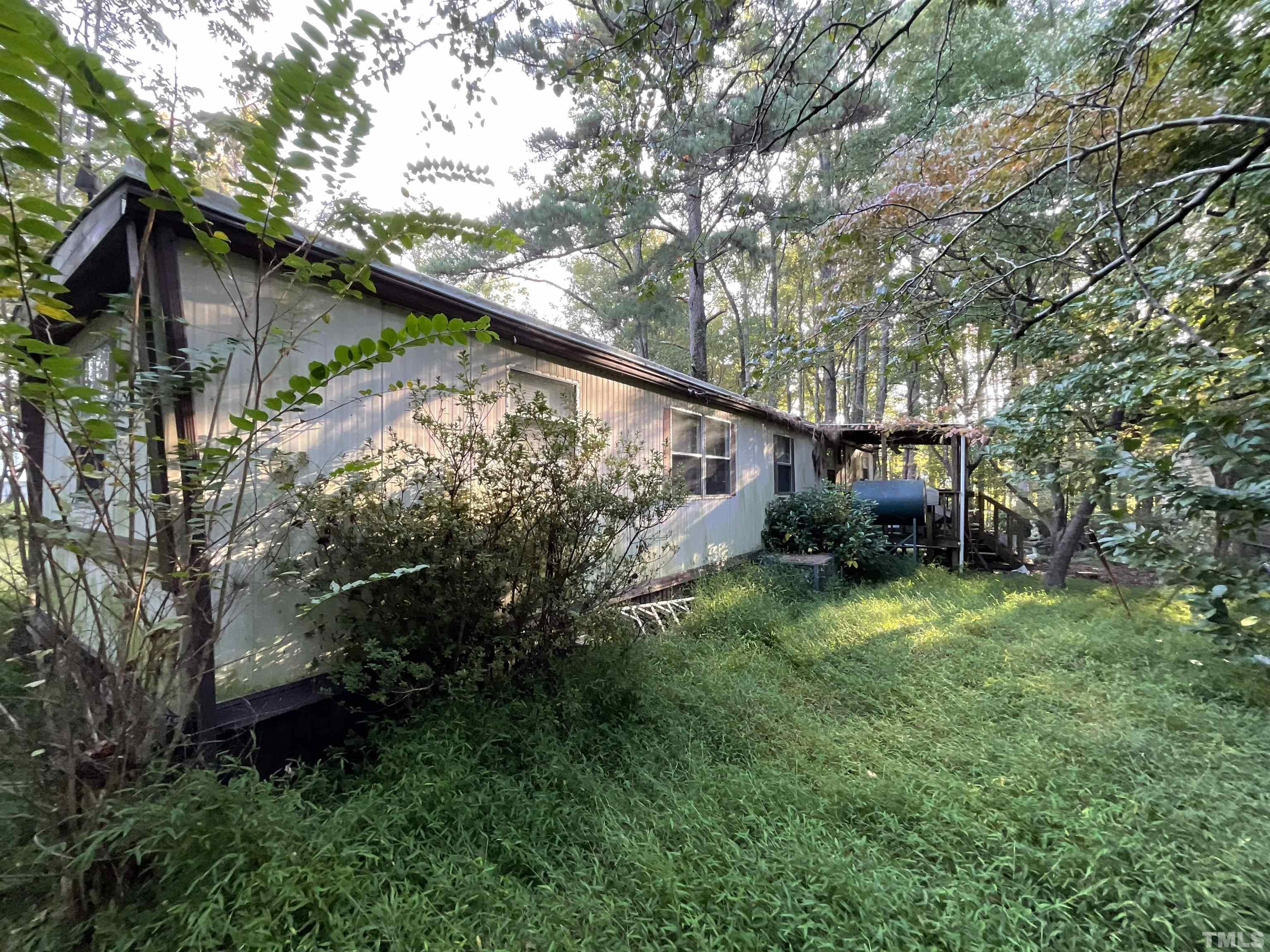 8229 Holly Springs Road Raleigh, NC 27606 - Photo 9 of 24 a backyard of a house with lots of green space