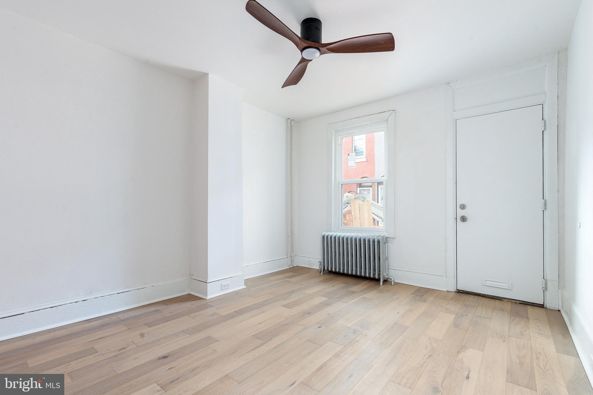 2143 Palethorp Street Philadelphia, PA 19122 - Photo 10 of 27 an empty room with wooden floor and windows