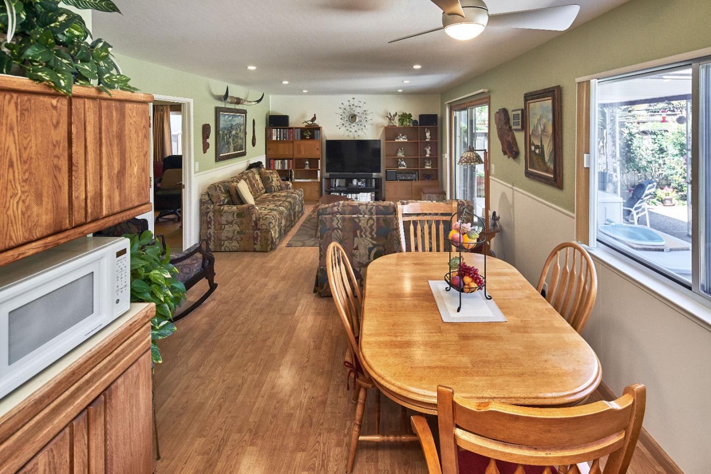 763 Upton Way San Jose, CA 95136 - Photo 12 of 32 a dining room with furniture a flat screen tv and wooden floor
