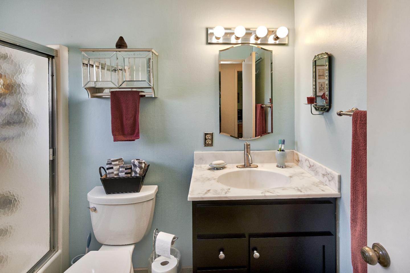 763 Upton Way San Jose, CA 95136 - Photo 19 of 32 a bathroom with a toilet sink and mirror