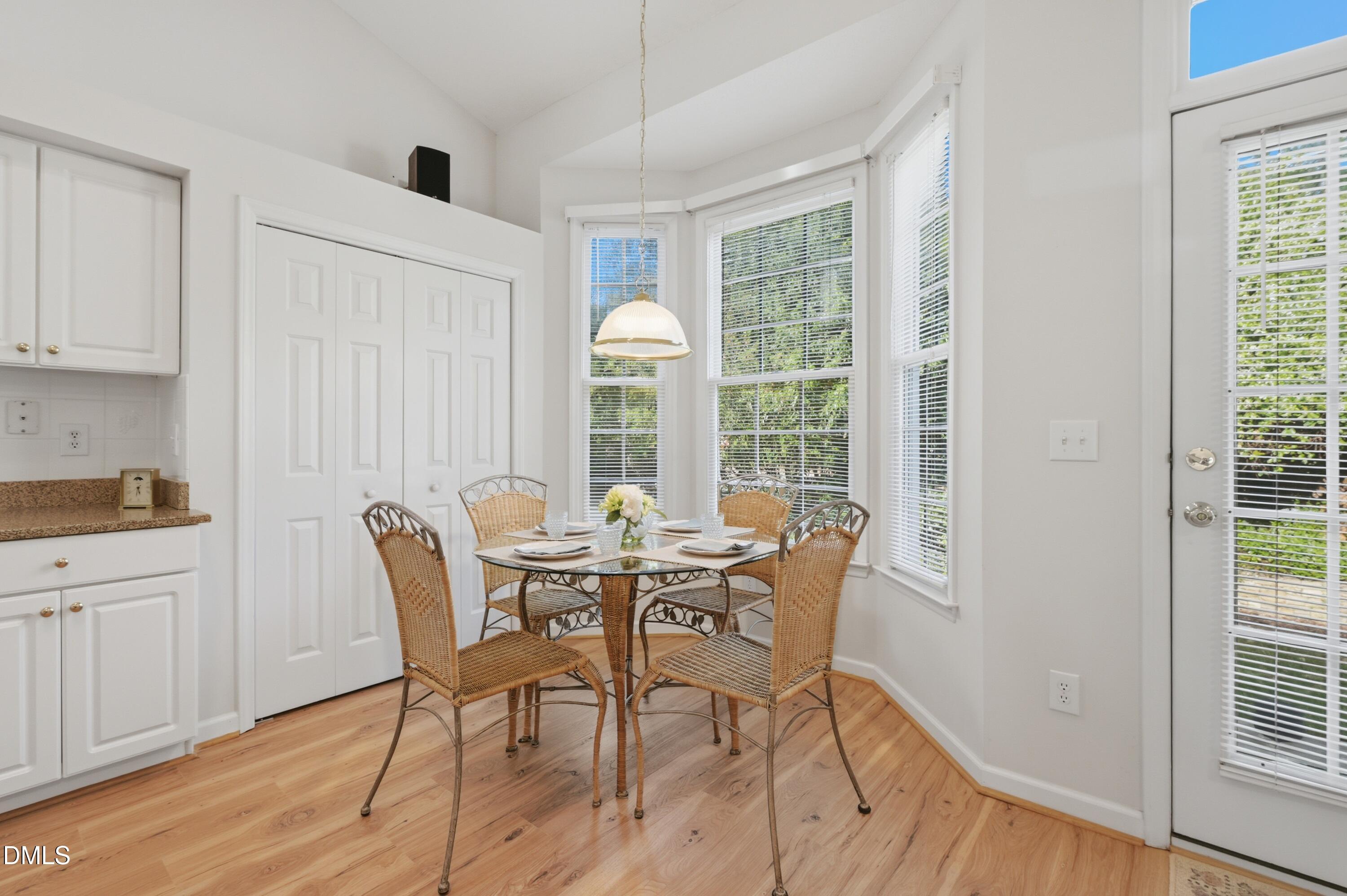 6801 Lynnoak Drive Raleigh, NC 27613 - Photo 12 of 30 a view of a dining room with furniture and wooden floor