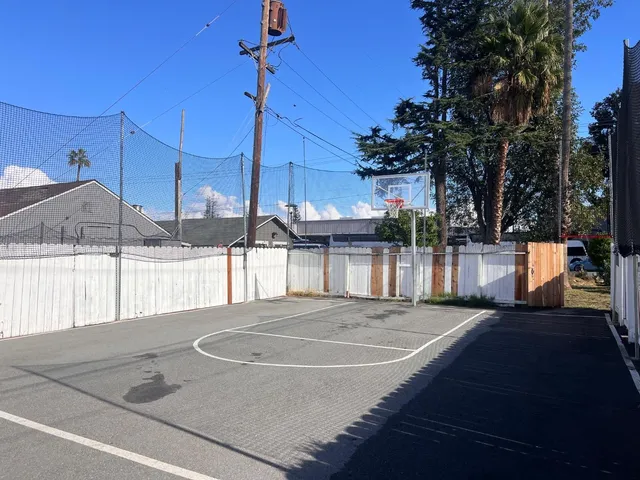 a view of a house with a wooden fence
