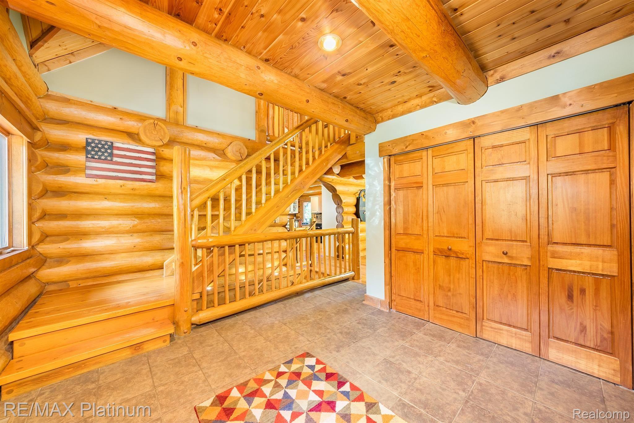 8335 Cedar Lake Road Pinckney, MI 48169 - Photo 12 of 55 Entry Hall Closet and Staircase