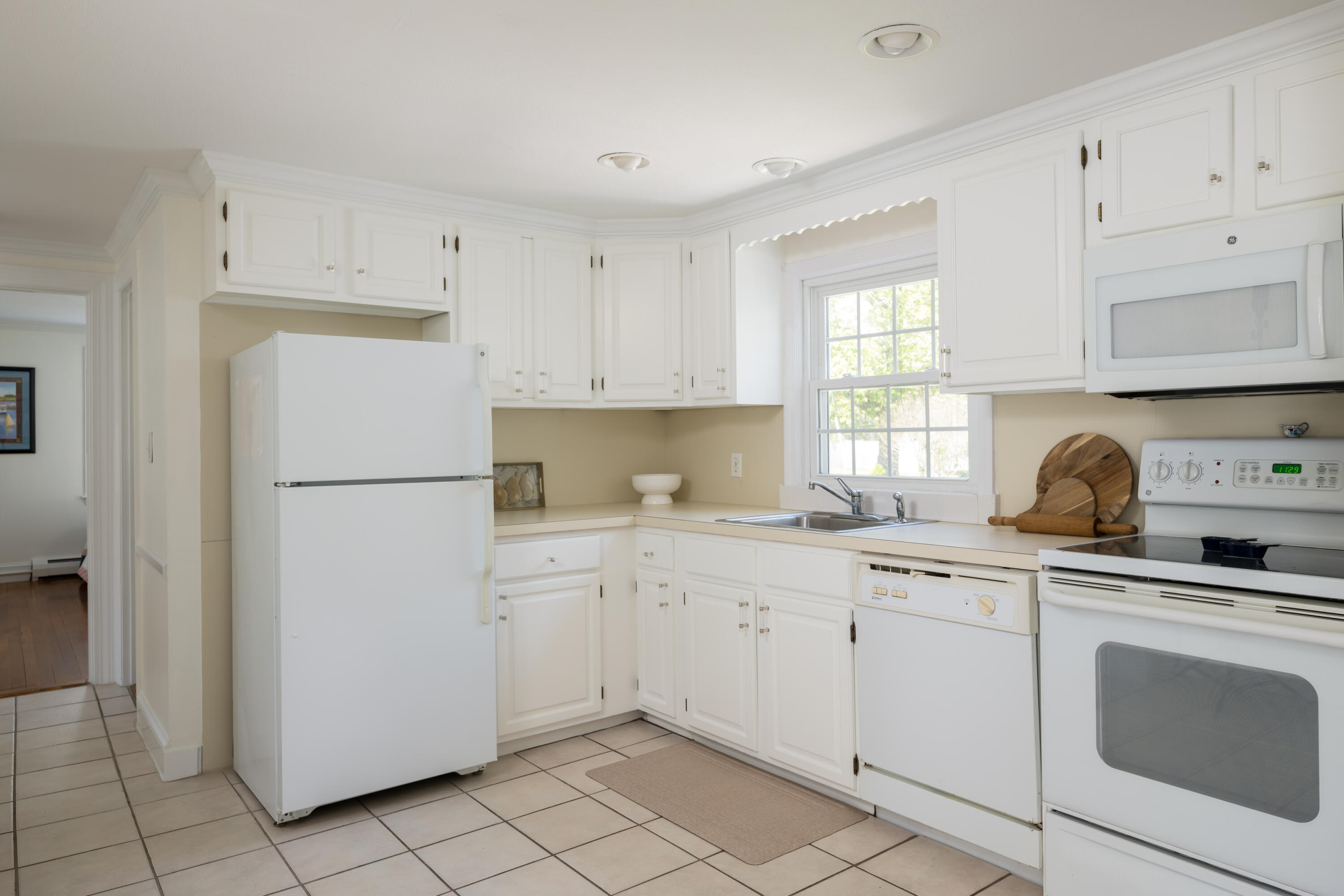 111 Lewis Road West Yarmouth, MA 02673 - Photo 16 of 43 a kitchen with white cabinets and white appliances