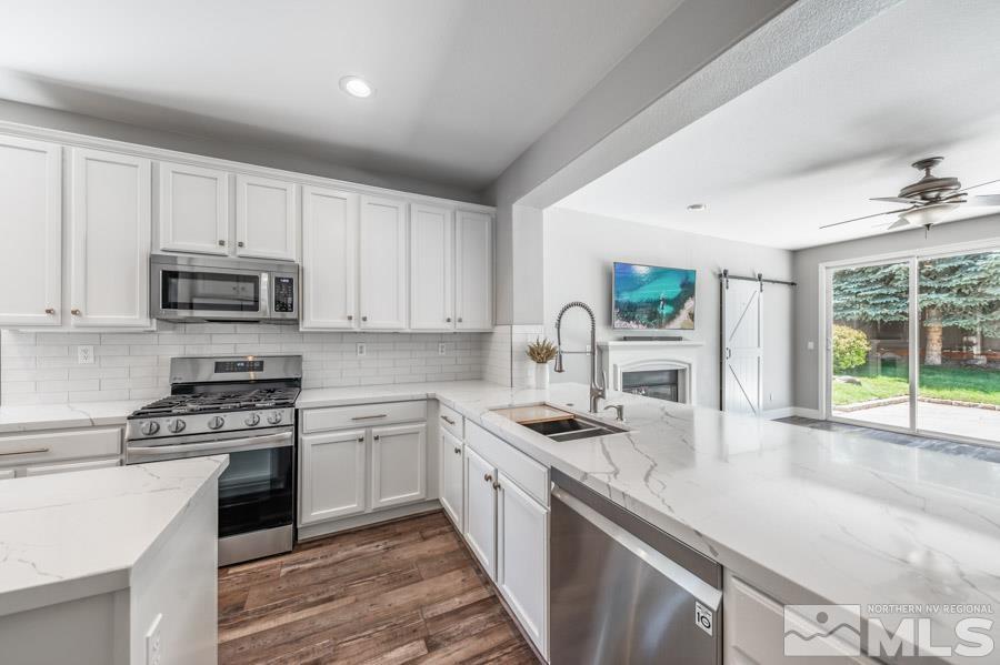 580 Beckfield Court Reno, NV 89521 - Photo 8 of 23 a kitchen with sink a stove and cabinets