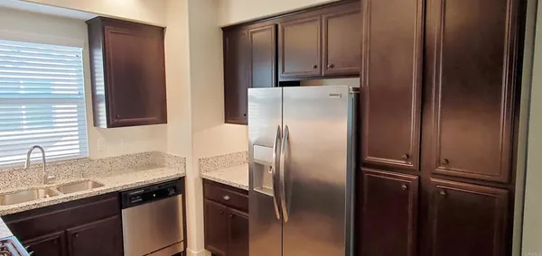 a kitchen with a refrigerator and a sink