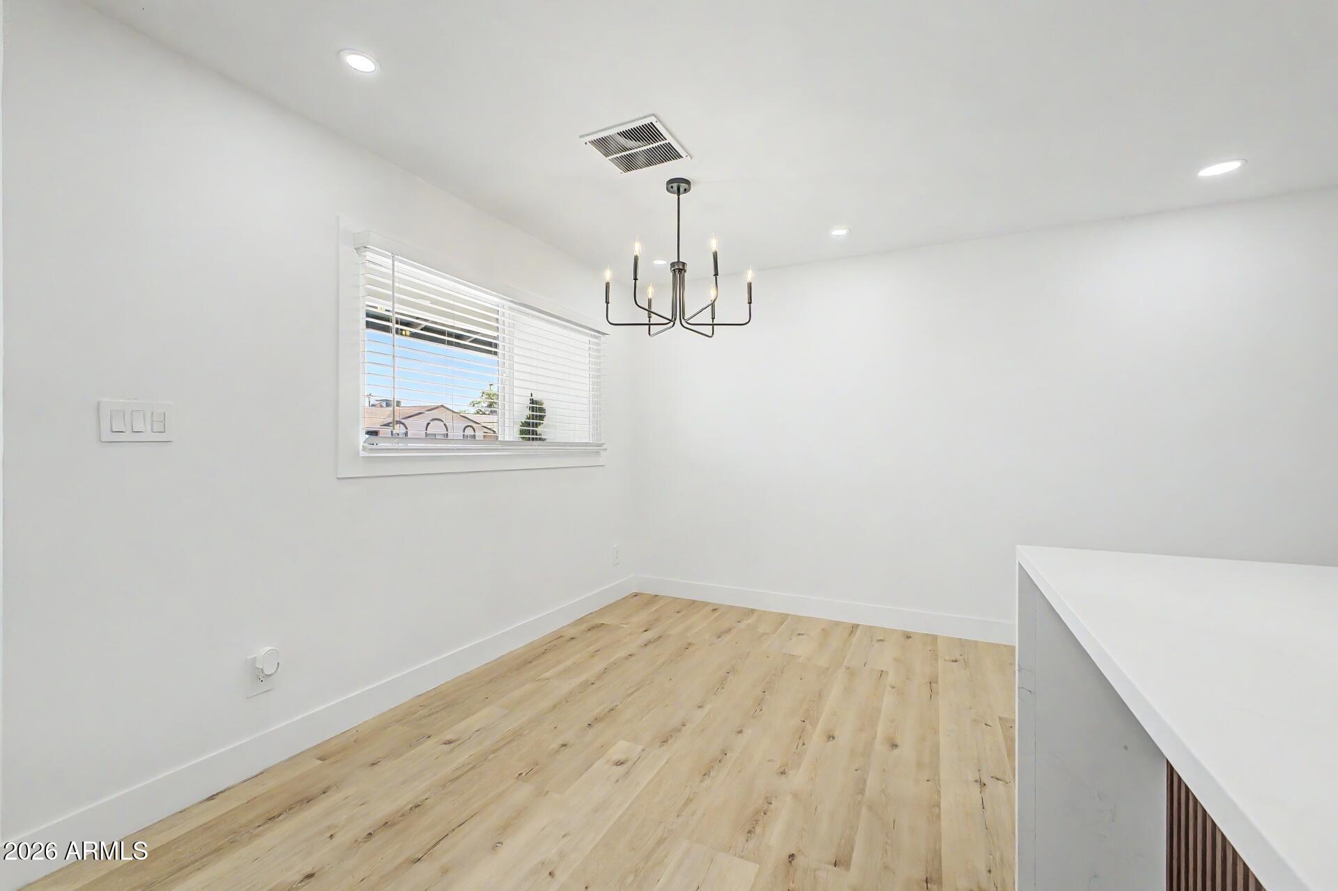 5232 West Hearn Road Glendale, AZ 85306 - Photo 6 of 32 a view of empty room with wooden floor