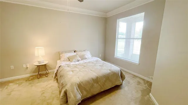 a bed sitting in a bedroom next to a window