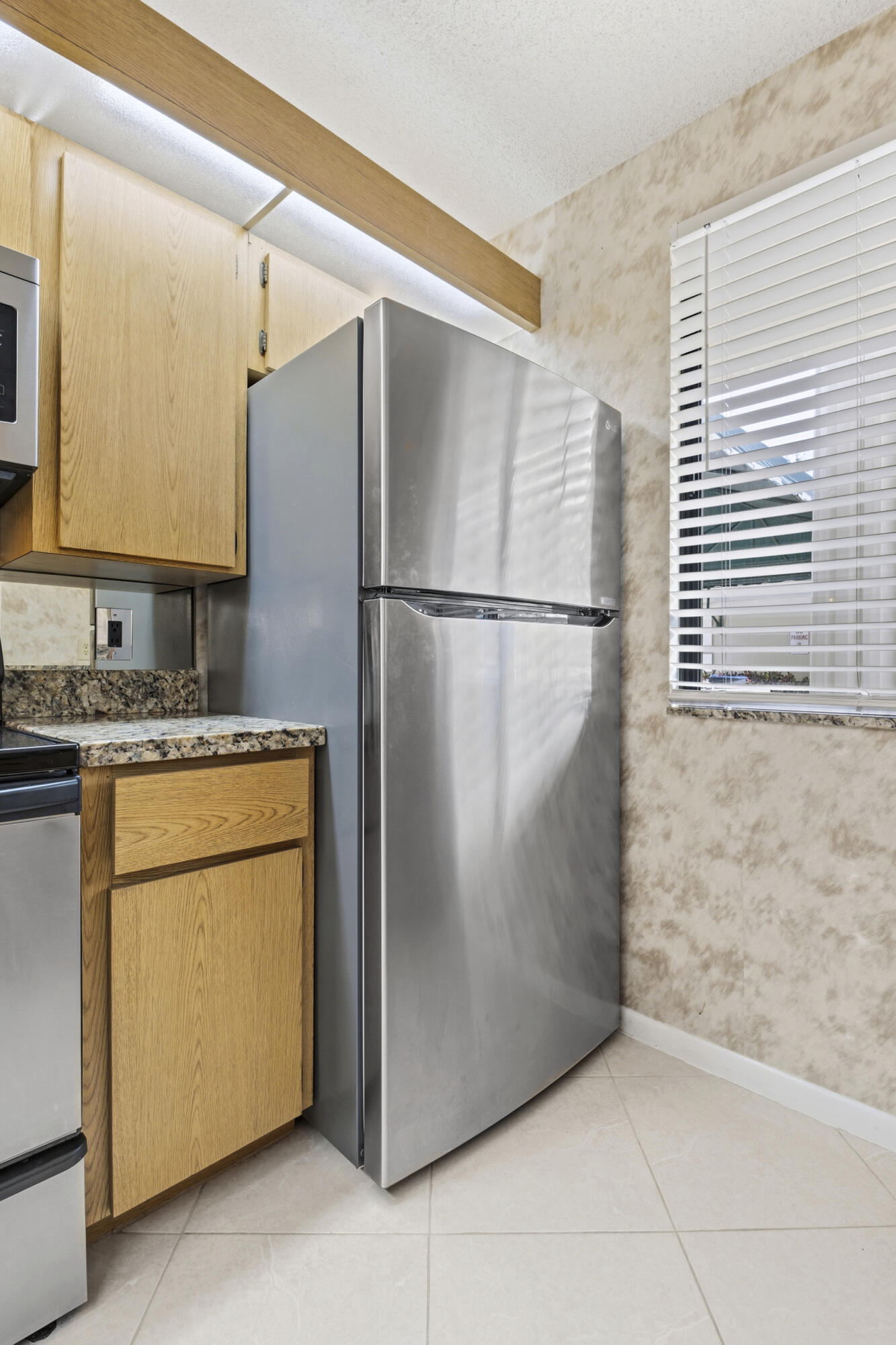 6145 Balboa Circle, Unit 103 Boca Raton, FL 33433 - Photo 7 of 31 a white refrigerator freezer sitting in a kitchen