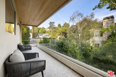 a view of a balcony with furniture