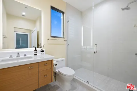a bathroom with a toilet a sink and shower