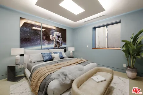 a bed room with a bed and a potted plant