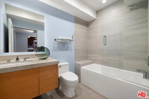 a bathroom with a toilet a sink and bathtub