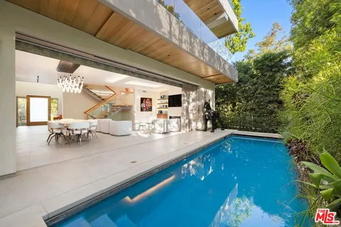 a view of swimming pool with outdoor seating