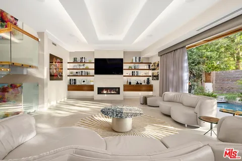 a living room with fireplace furniture and a flat screen tv