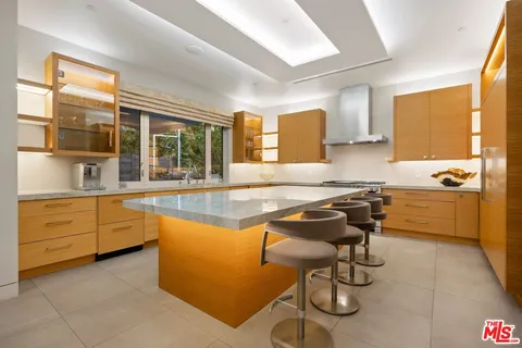 a kitchen with a sink appliances and cabinets