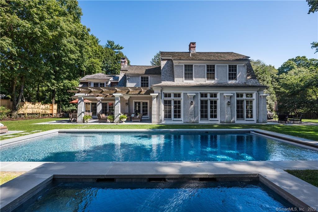 100 Compo Road South Westport, CT 06880 - Photo 1 of 1 a front view of residential houses with yard and swimming pool