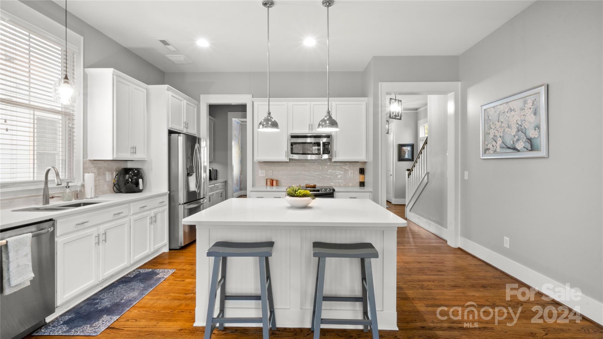 444 Hollyhock Lane Fort Mill, SC 29708 - Photo 12 of 30 a kitchen with sink a refrigerator and white cabinets