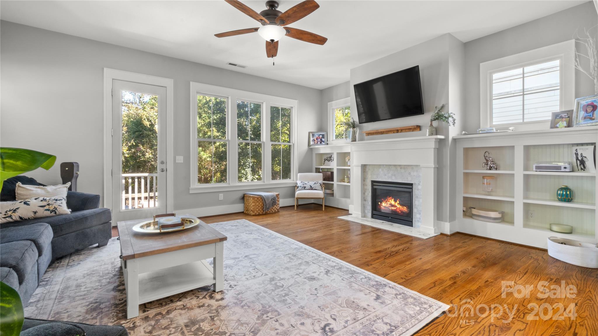 444 Hollyhock Lane Fort Mill, SC 29708 - Photo 14 of 30 a living room with furniture a fireplace and a flat screen tv
