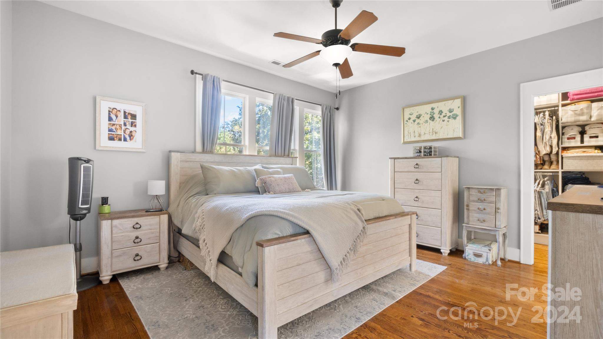 444 Hollyhock Lane Fort Mill, SC 29708 - Photo 16 of 30 a spacious bedroom with a bed a couch and a window