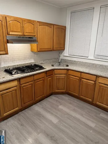 a kitchen with stainless steel appliances granite countertop a sink stove and cabinets