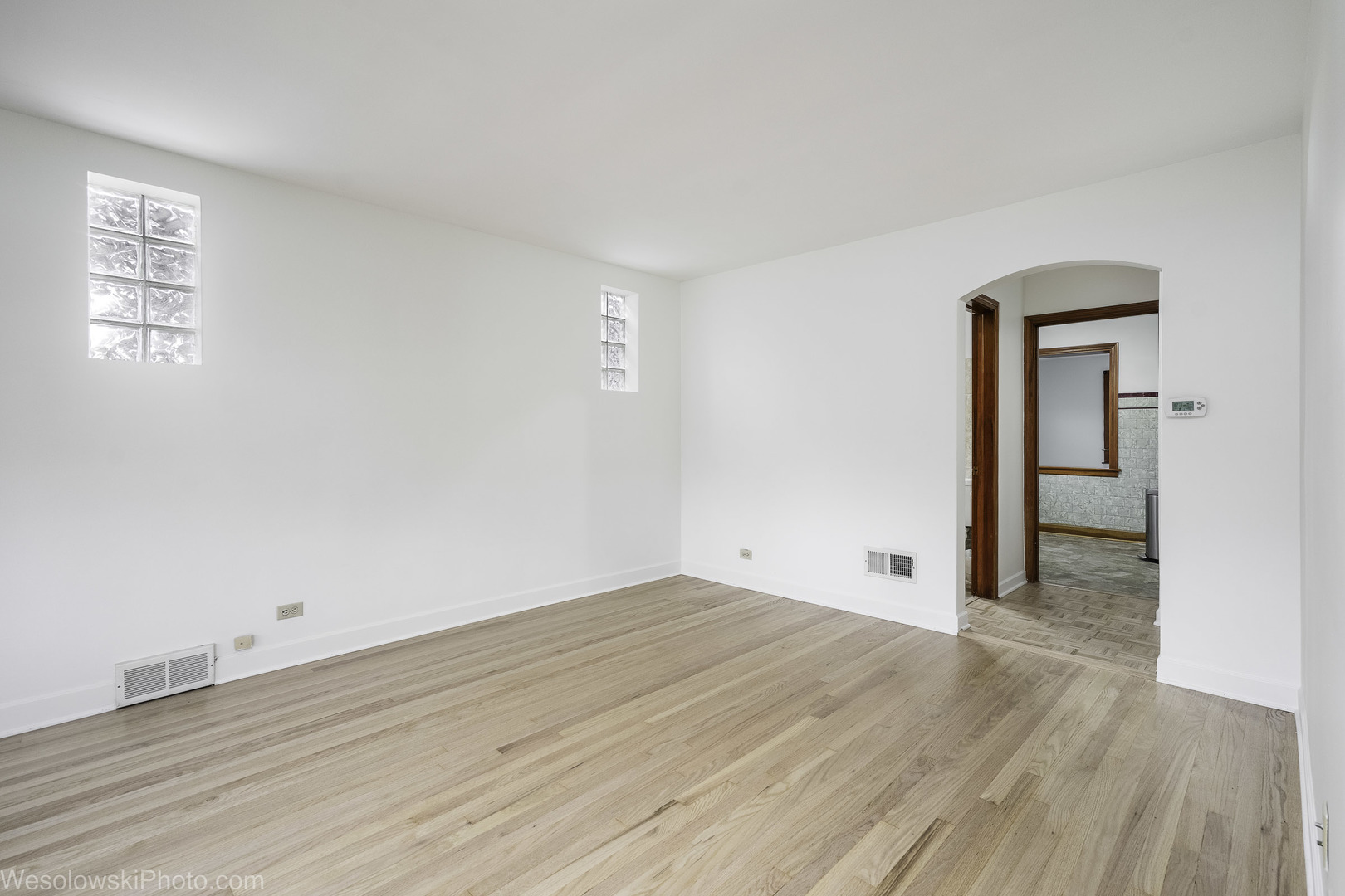 5944 West Foster Avenue Chicago, IL 60630 - Photo 5 of 21 an empty room with wooden floor and windows