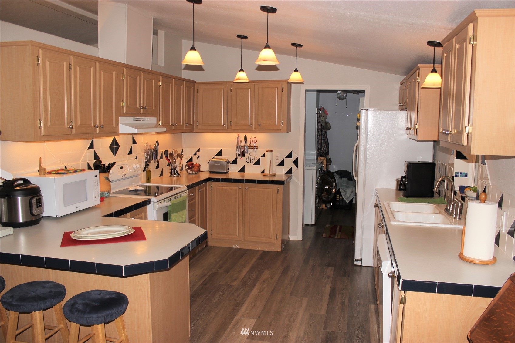 6313 190th Lane Southwest Rochester, WA 98579 - Photo 13 of 37 a kitchen with a sink refrigerator and cabinets