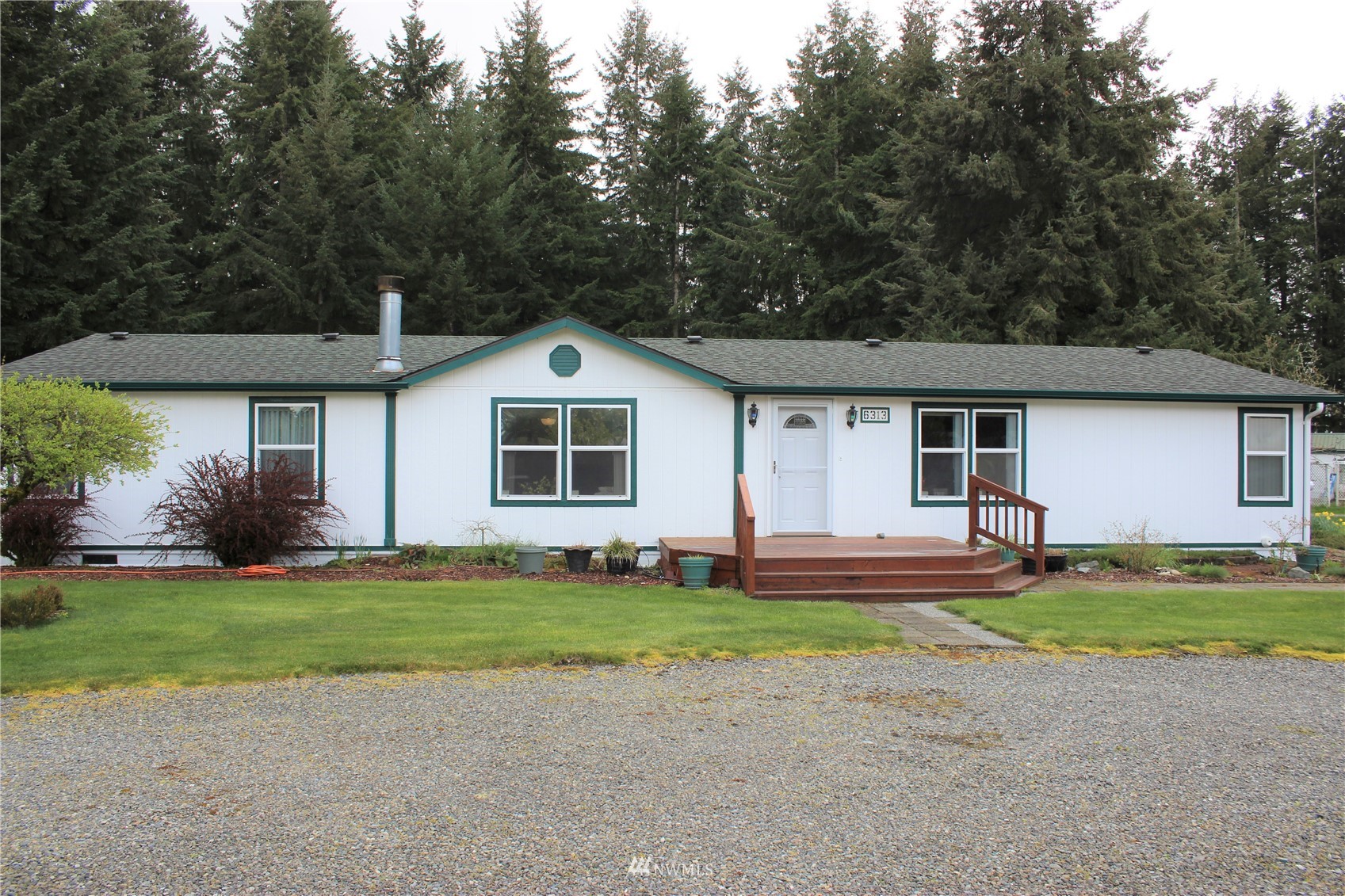 6313 190th Lane Southwest Rochester, WA 98579 - Photo 4 of 37 a front view of a house with a yard and garage