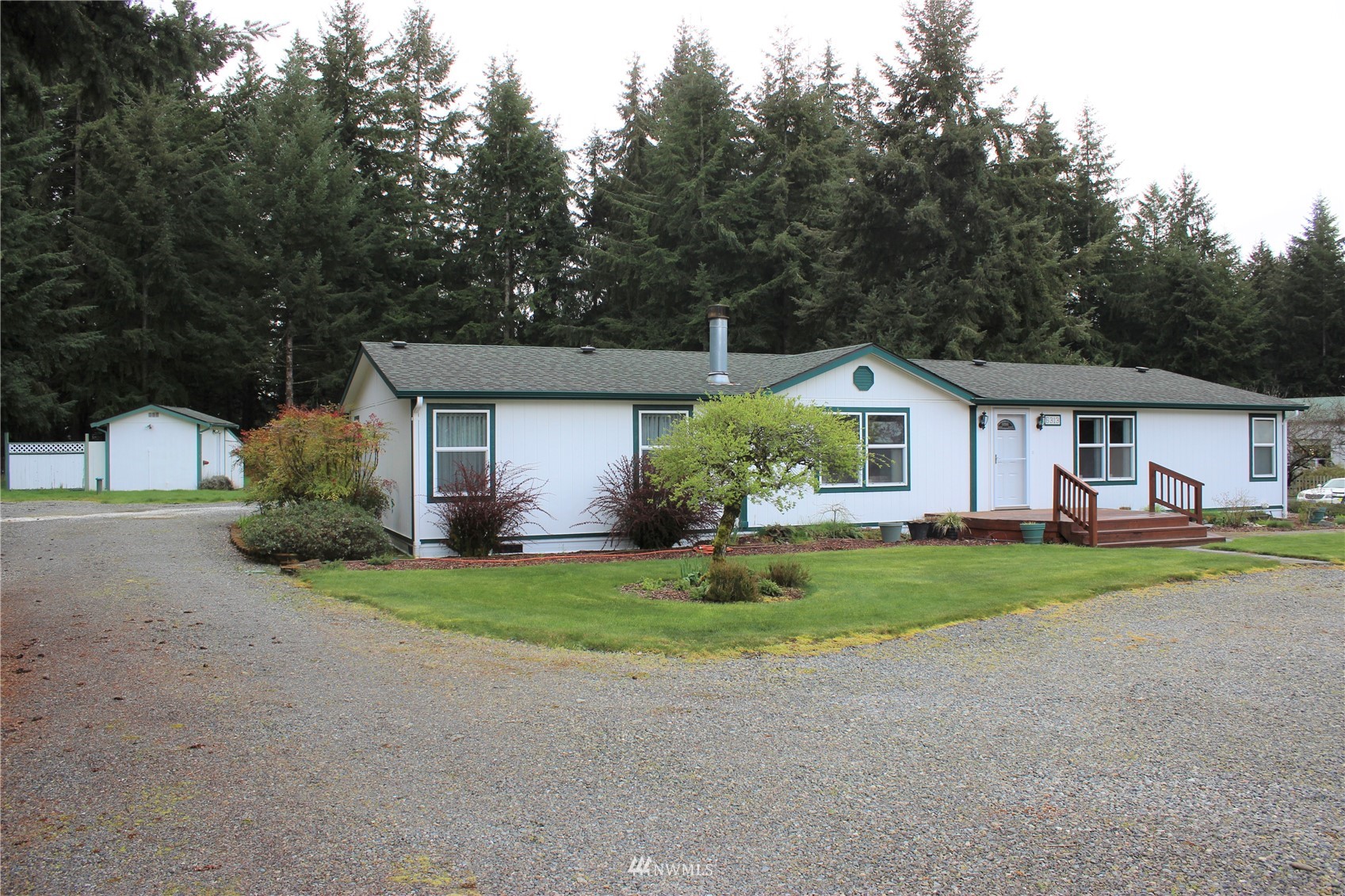 6313 190th Lane Southwest Rochester, WA 98579 - Photo 5 of 37 a front view of a house with a yard and garage