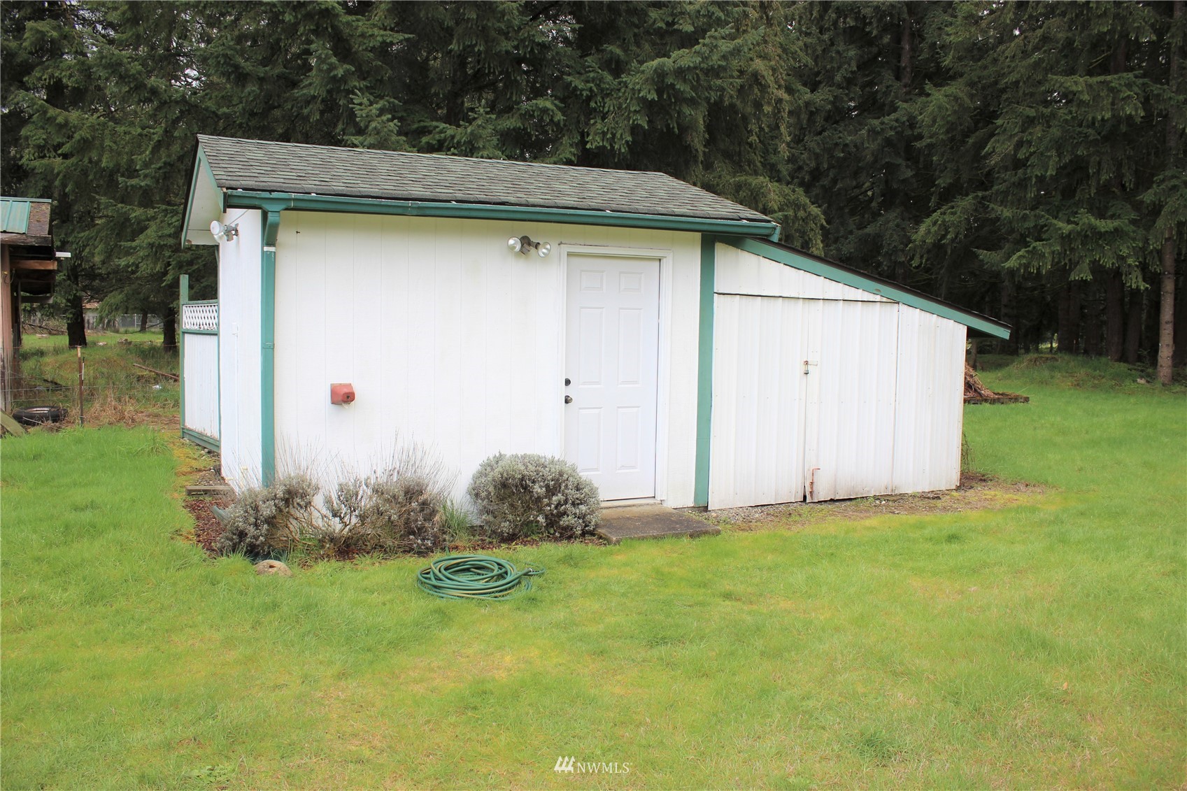 6313 190th Lane Southwest Rochester, WA 98579 - Photo 8 of 37 a backyard of a house with plants and garden