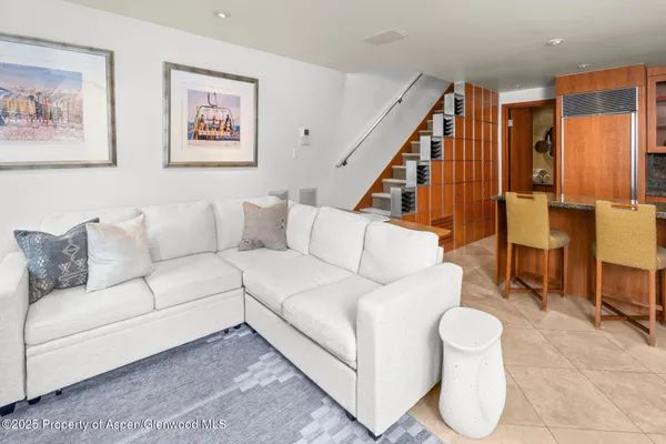 a living room with furniture and a painting