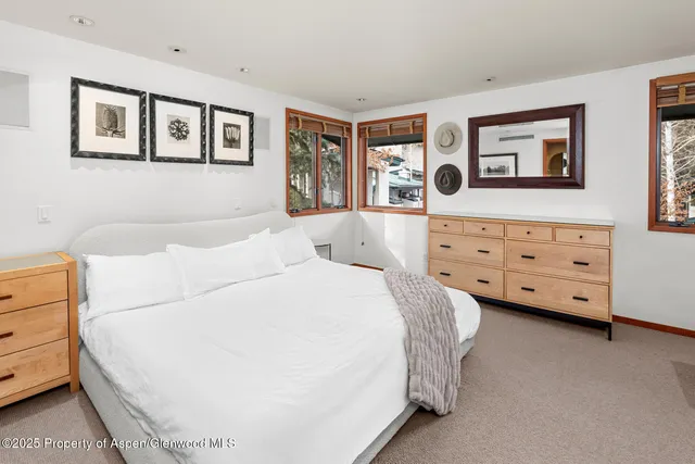 a bed room with a bed and a dresser