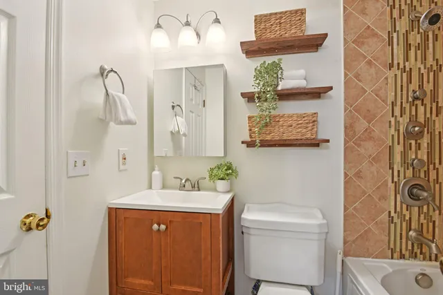 a bathroom with a sink a toilet and shower curtain