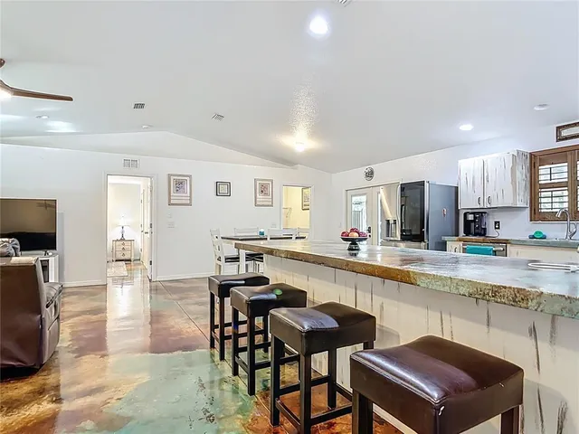 a kitchen with stainless steel appliances granite countertop a refrigerator sink and stove