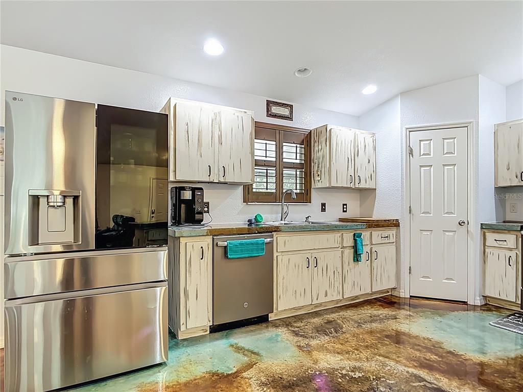 3114 Southeast Brown Road Arcadia, FL 34266 - Photo 16 of 61 a kitchen with stainless steel appliances granite countertop a refrigerator sink and stove