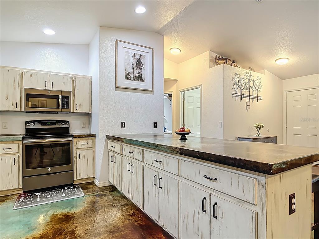 3114 Southeast Brown Road Arcadia, FL 34266 - Photo 18 of 61 a kitchen with stainless steel appliances granite countertop a stove a sink and a microwave