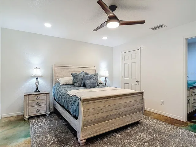 a bathroom with a granite countertop sink and a toilet