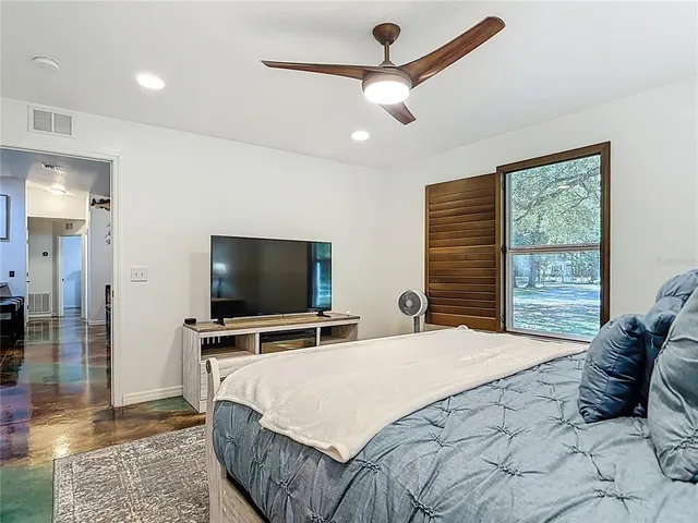 a view of a livingroom with a ceiling fan and window