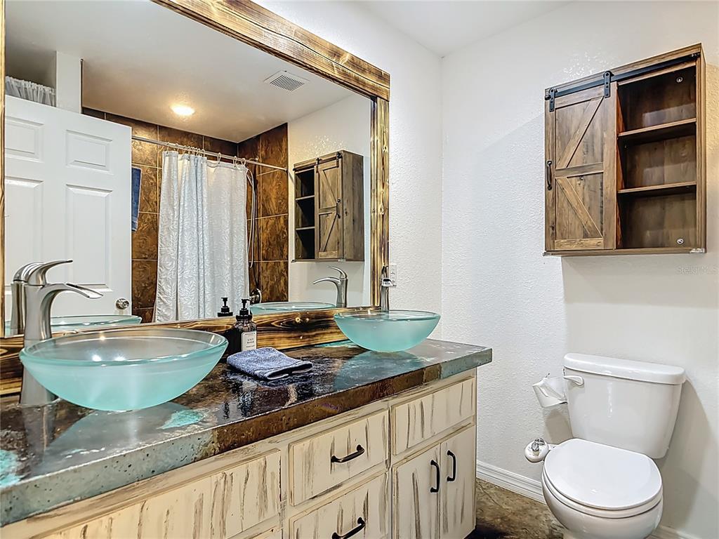 3114 Southeast Brown Road Arcadia, FL 34266 - Photo 29 of 61 a bathroom with a granite countertop sink and a toilet