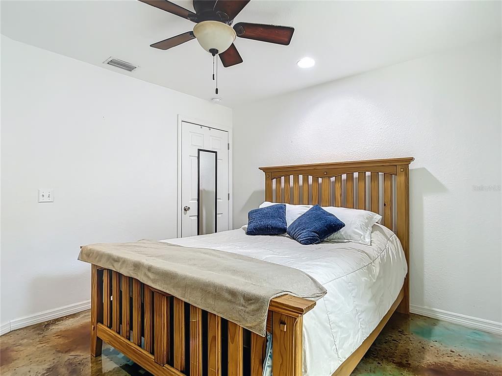 3114 Southeast Brown Road Arcadia, FL 34266 - Photo 36 of 61 a bedroom with a bed and a chandelier