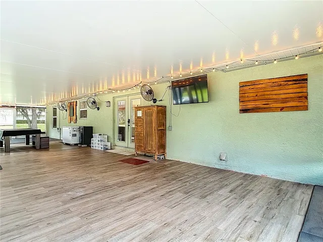 a view of a house with a yard and large tree