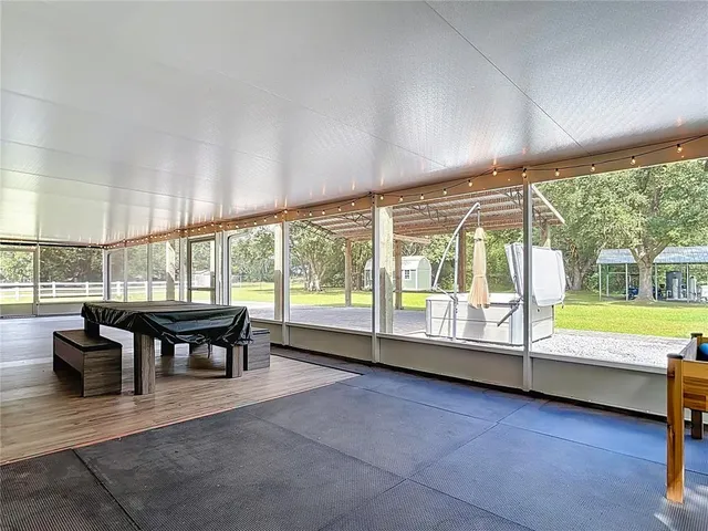 a front view of a house with a garden and trees