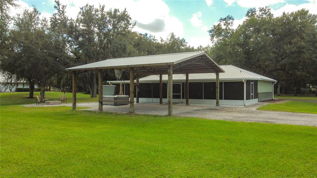3114 Southeast Brown Road Arcadia, FL 34266 - Photo 52 of 61 a front view of a house with a garden and trees
