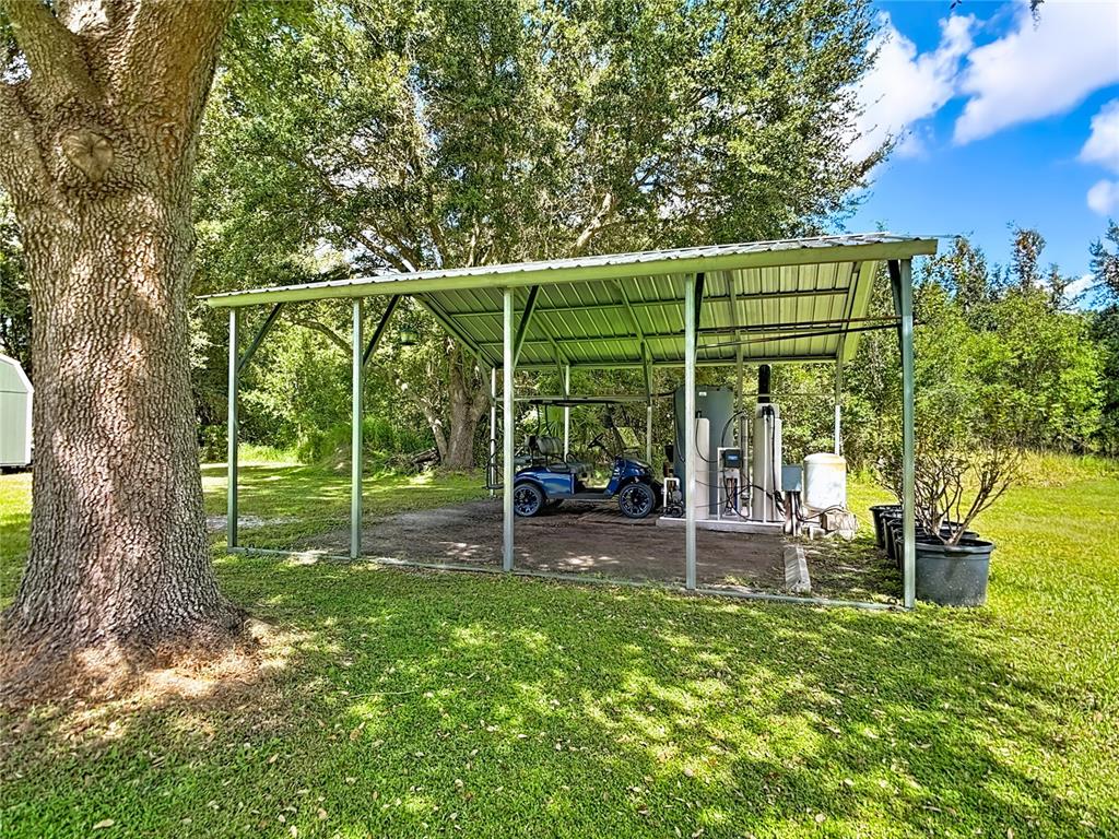 3114 Southeast Brown Road Arcadia, FL 34266 - Photo 56 of 61 a view of a backyard with table and chairs and potted plants with large trees