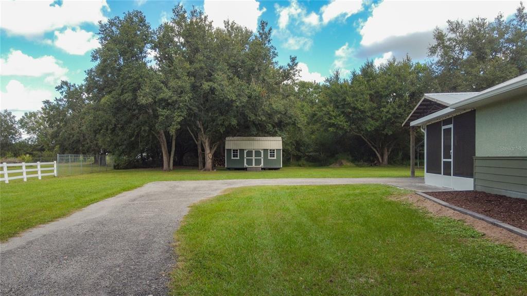 3114 Southeast Brown Road Arcadia, FL 34266 - Photo 57 of 61 a front view of a house with a yard and trees