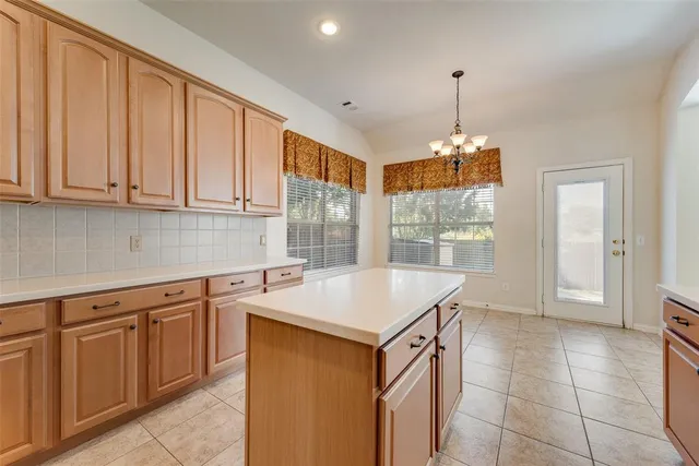 a kitchen that has a sink a stove and a wooden cabinets
