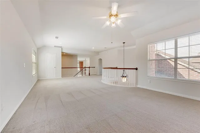 a view of a livingroom with a ceiling fan and window