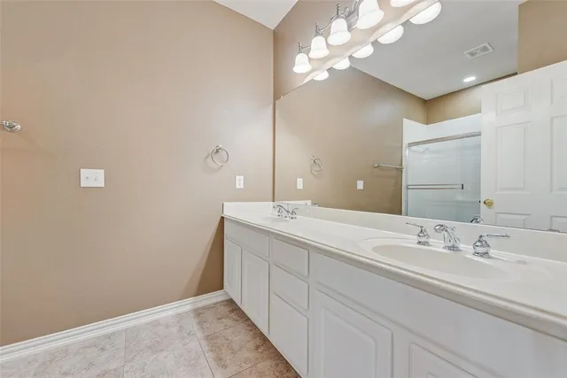 a bathroom with a sink vanity and a mirror
