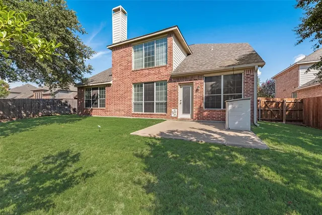 a front view of a house with a garden and yard