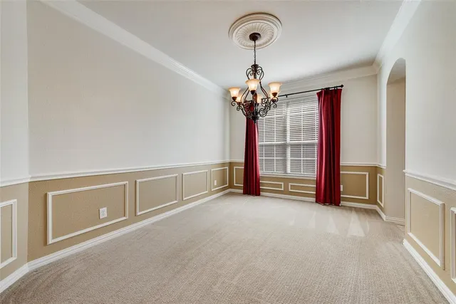 a view of an empty room with a chandelier